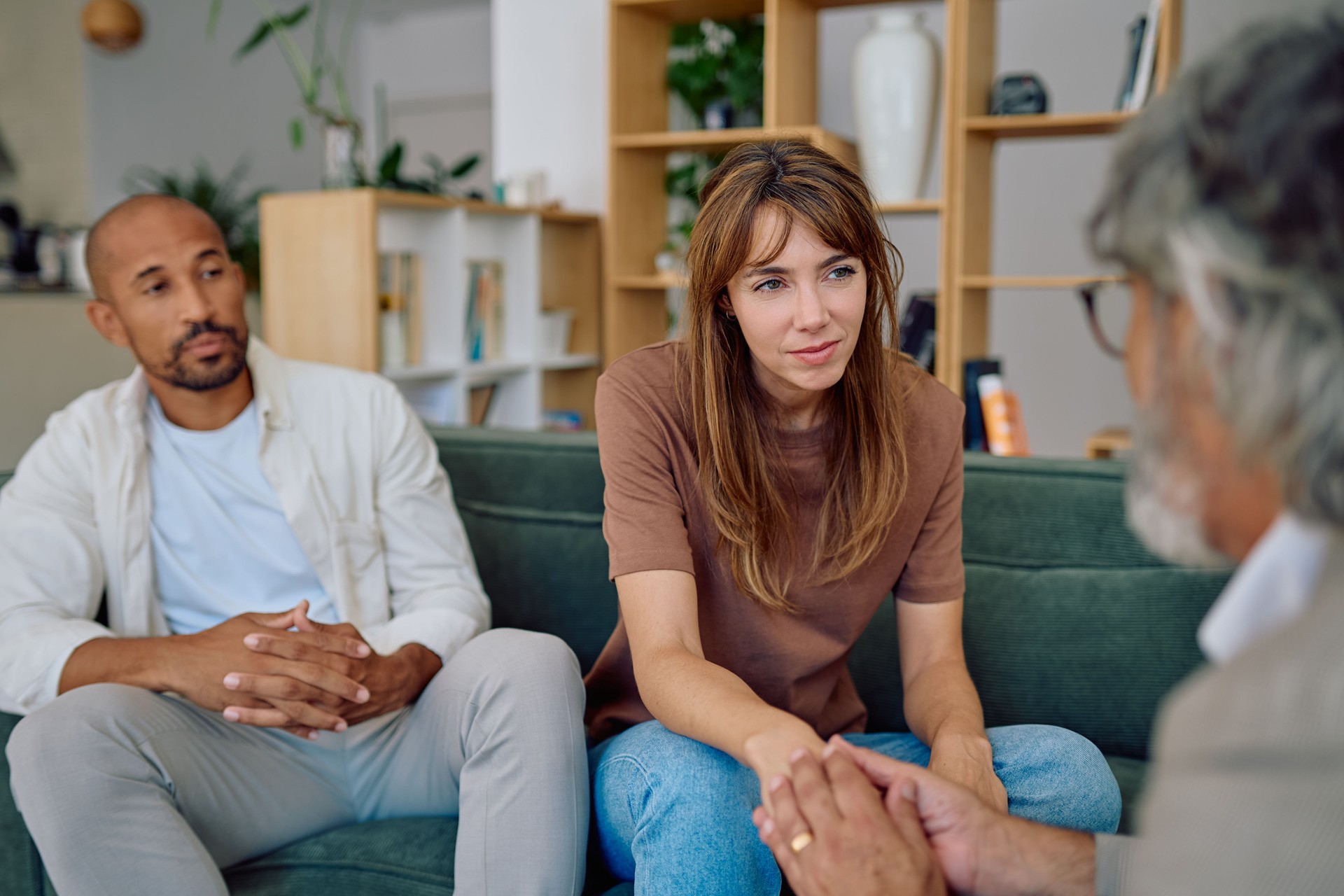 Couple discussing relationship problems with their therapist during therapy session